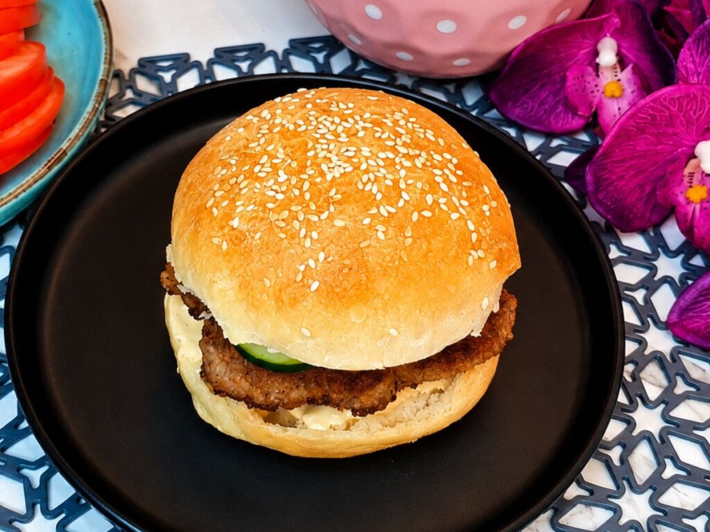 Freshly baked homemade burger buns topped with sesame seeds
