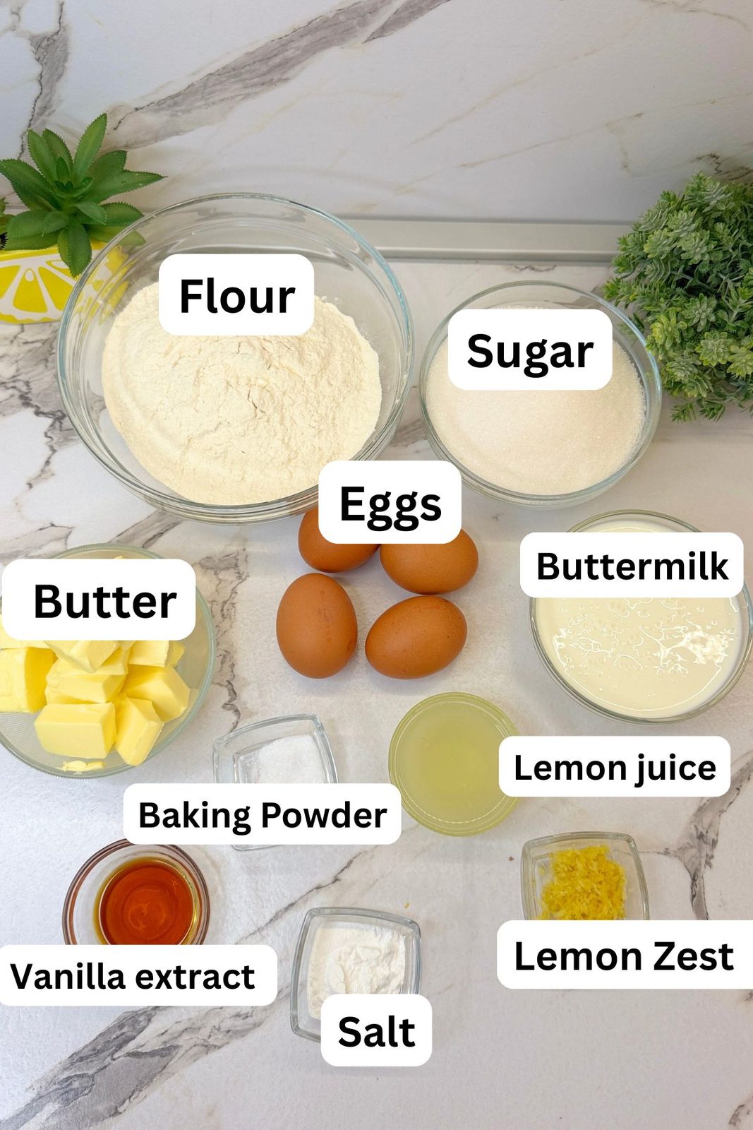 Ingredients for Lemon Blueberry Bundt Cake including flour, sugar, eggs, butter, buttermilk, lemon juice, lemon zest, vanilla, baking powder, and salt
