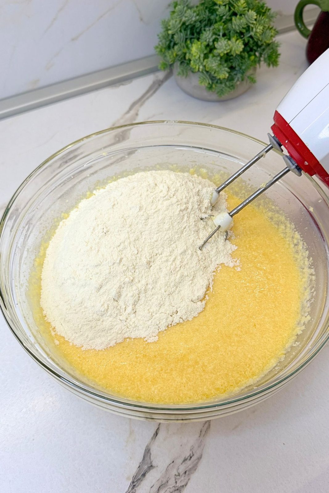 Dry ingredients added to the wet mixture for Lemon Blueberry Bundt Cake