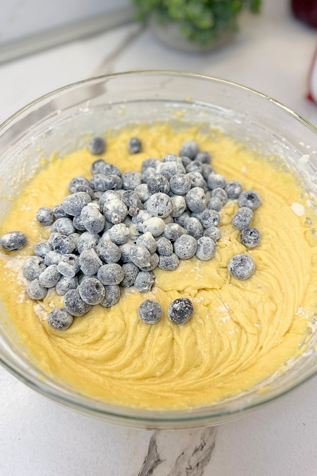 Flour-coated fresh blueberries added to thick lemon Bundt cake batter