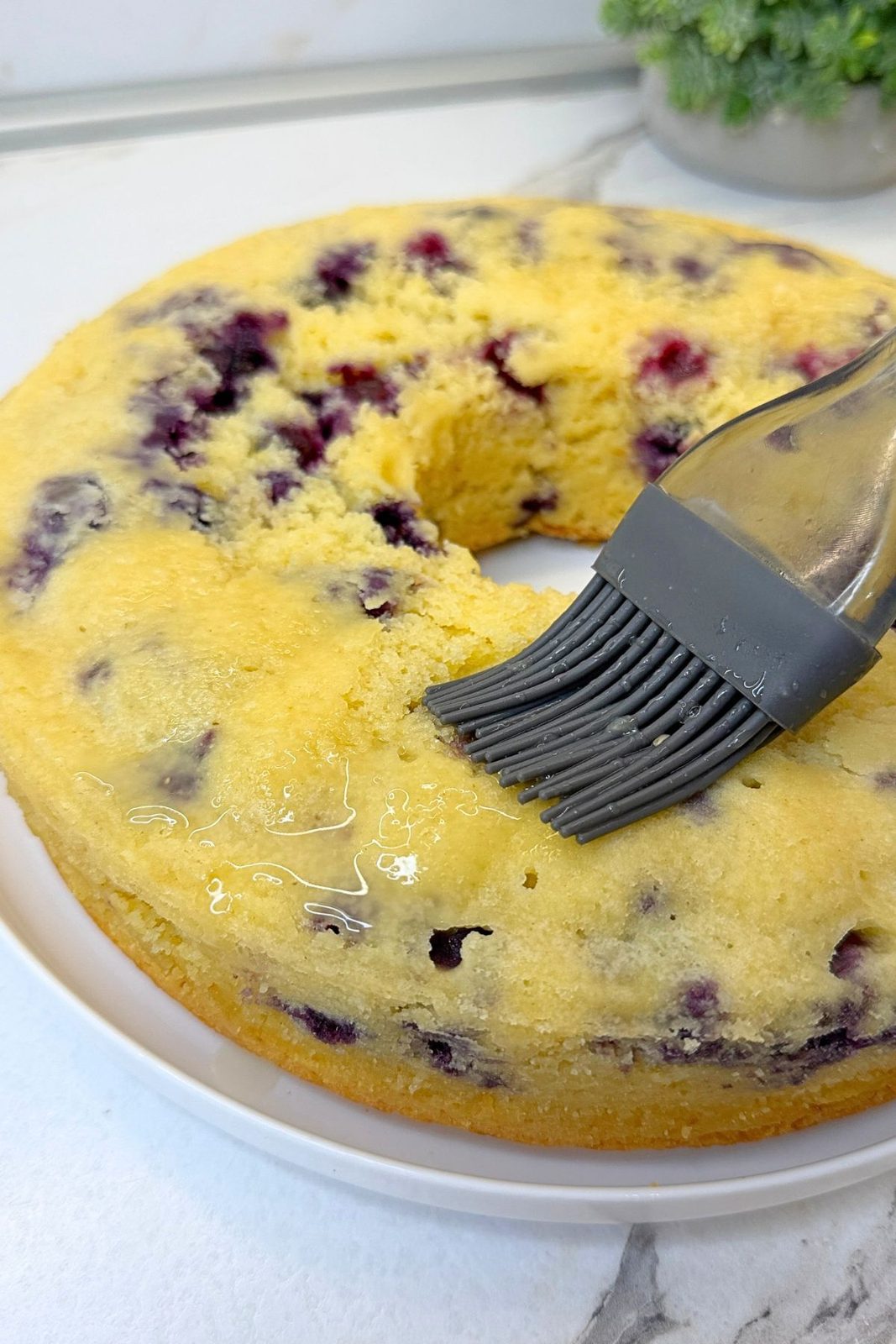 Warm Lemon Blueberry Bundt Cake brushed with homemade lemon syrup