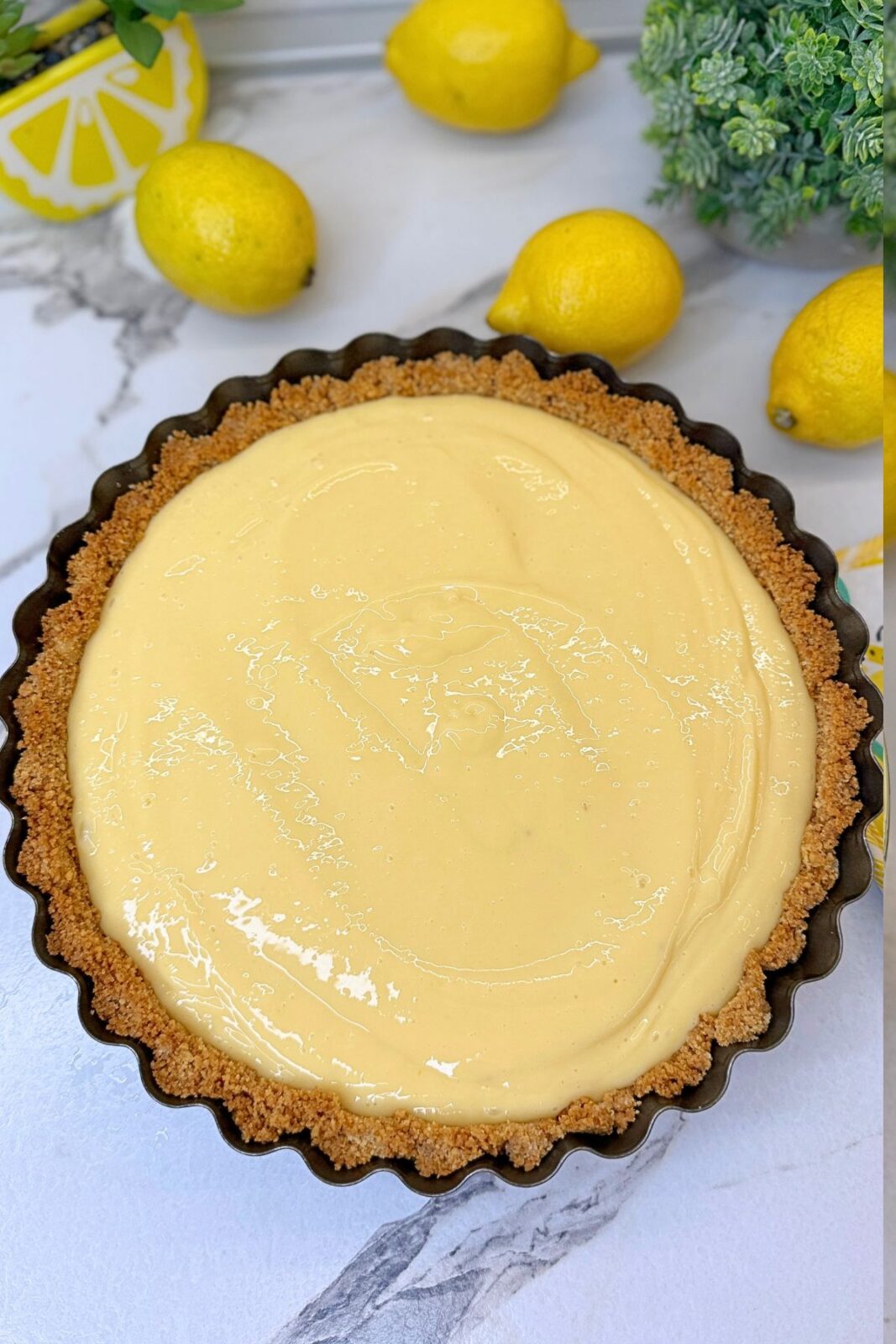 Creamy lemon filling poured evenly into the prebaked graham cracker crust