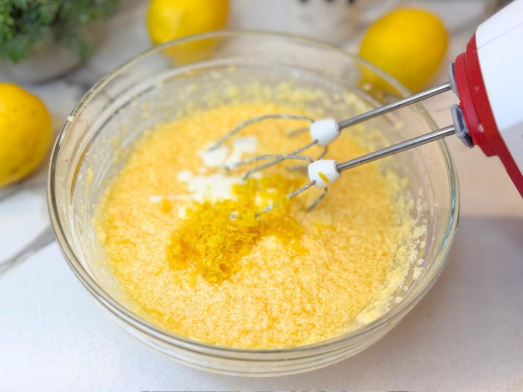 Lemon zest and wet ingredients mixed for lemon pound cake batter