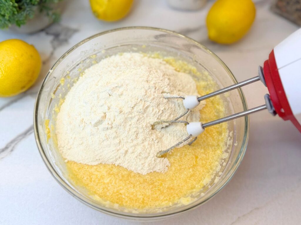Dry ingredients added to the wet mixture for lemon pound cake