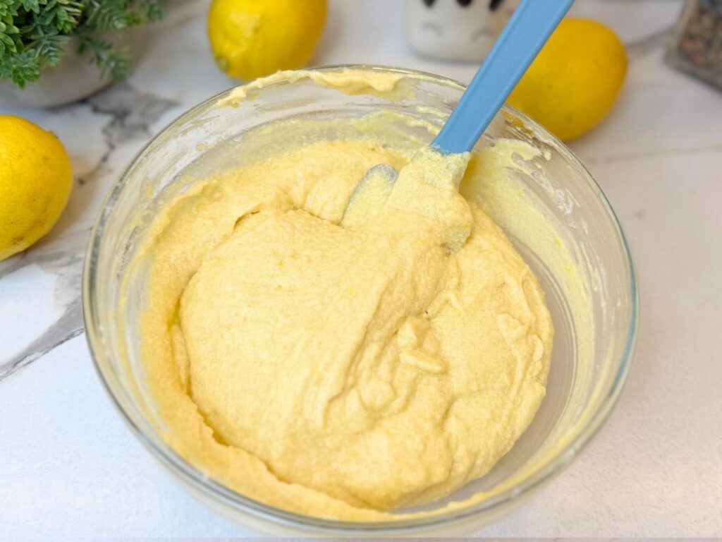 Smooth lemon pound cake batter mixed in a glass bowl
