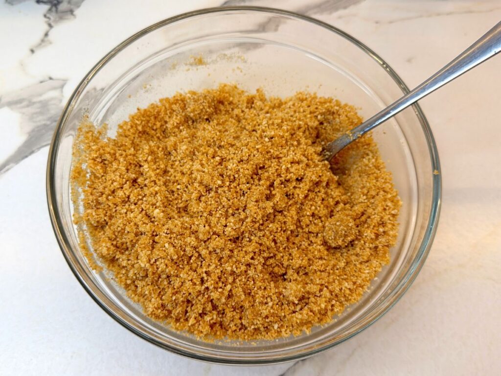 Cookie crumbs mixed with melted butter and sugar for the cheesecake crust