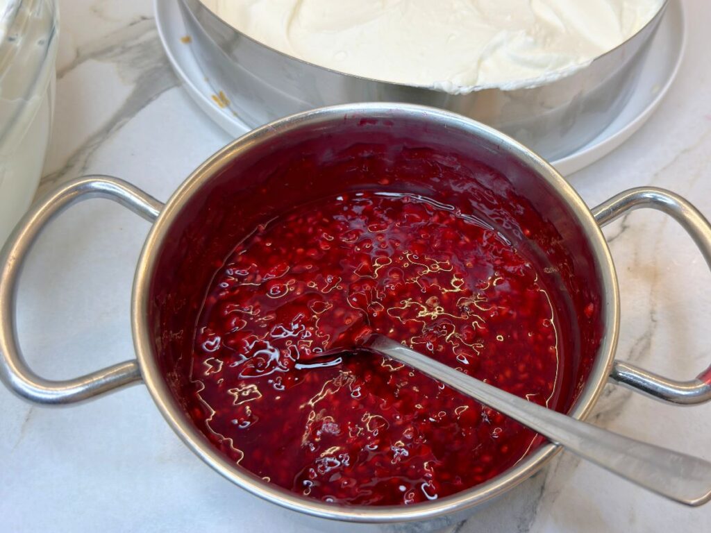 Homemade mixed berry topping cooked until thick and glossy.