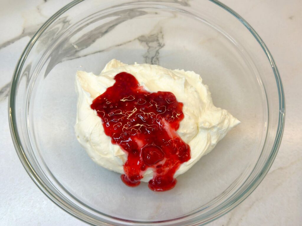 Mixed berry topping added to a portion of the cheesecake filling.