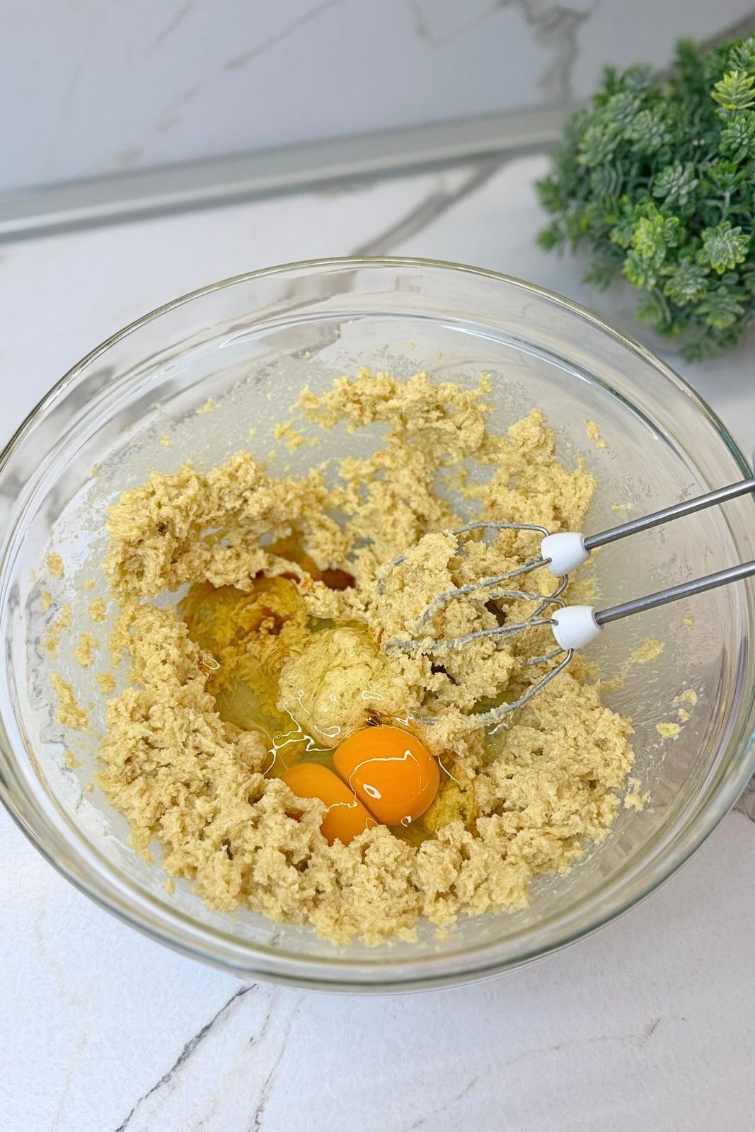 Eggs and vanilla added to the creamed butter and sugar mixture