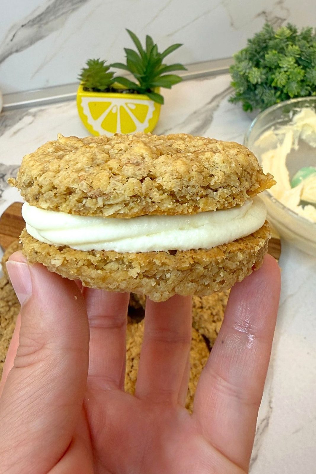Assembled homemade oatmeal cream pie with thick vanilla filling