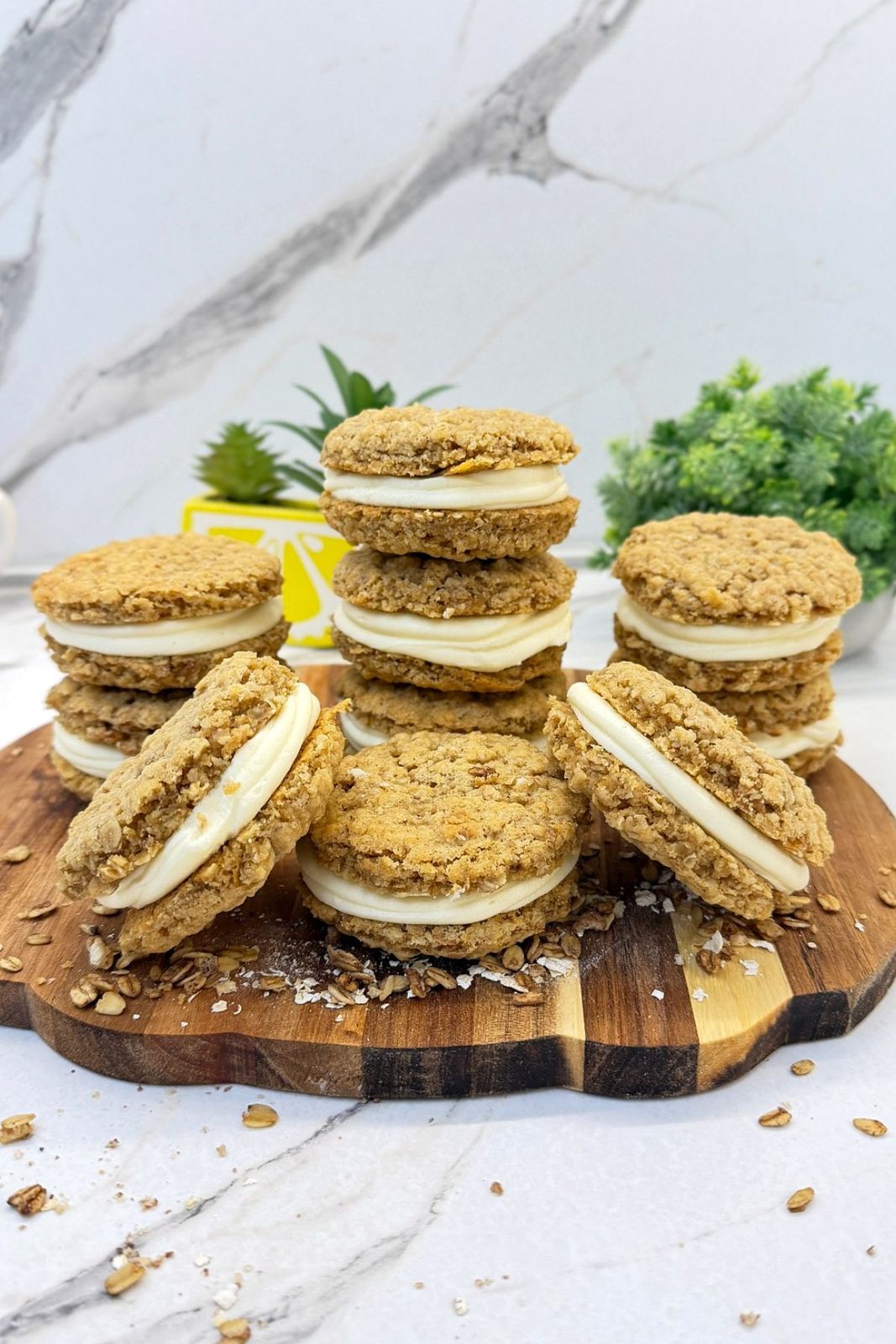 Homemade oatmeal cream pies with smooth vanilla filling arranged on a wooden serving board