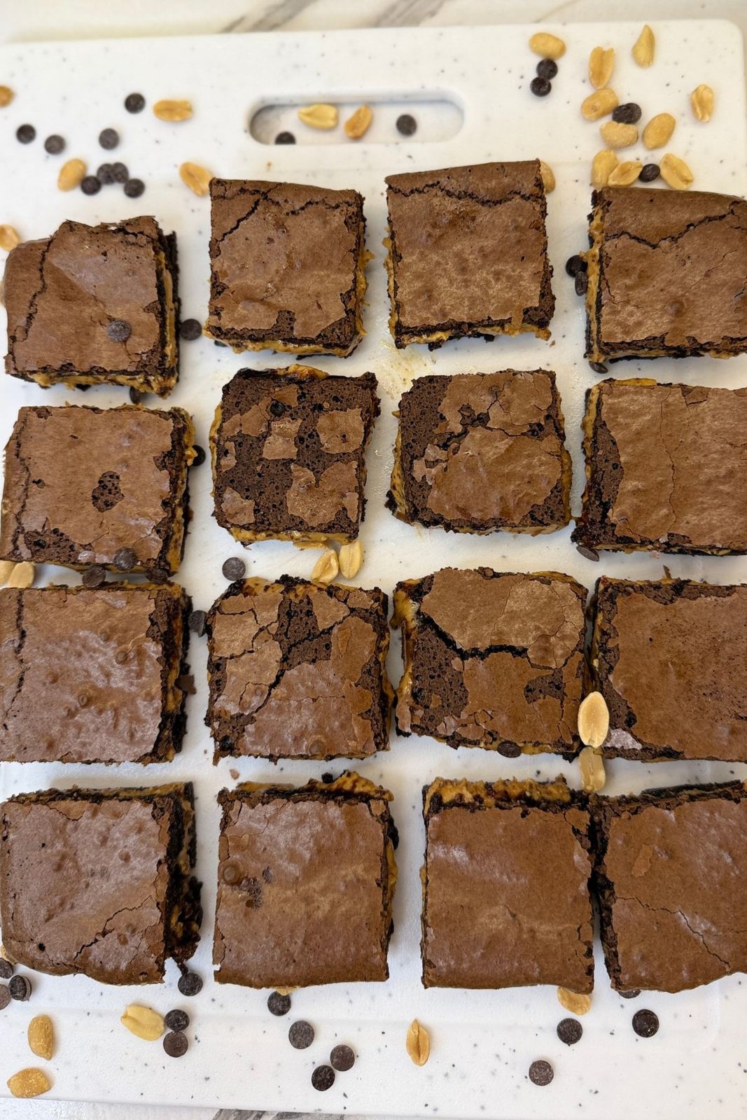 Stacked peanut butter brownie squares with fudgy chocolate layers and a thick creamy peanut butter center.