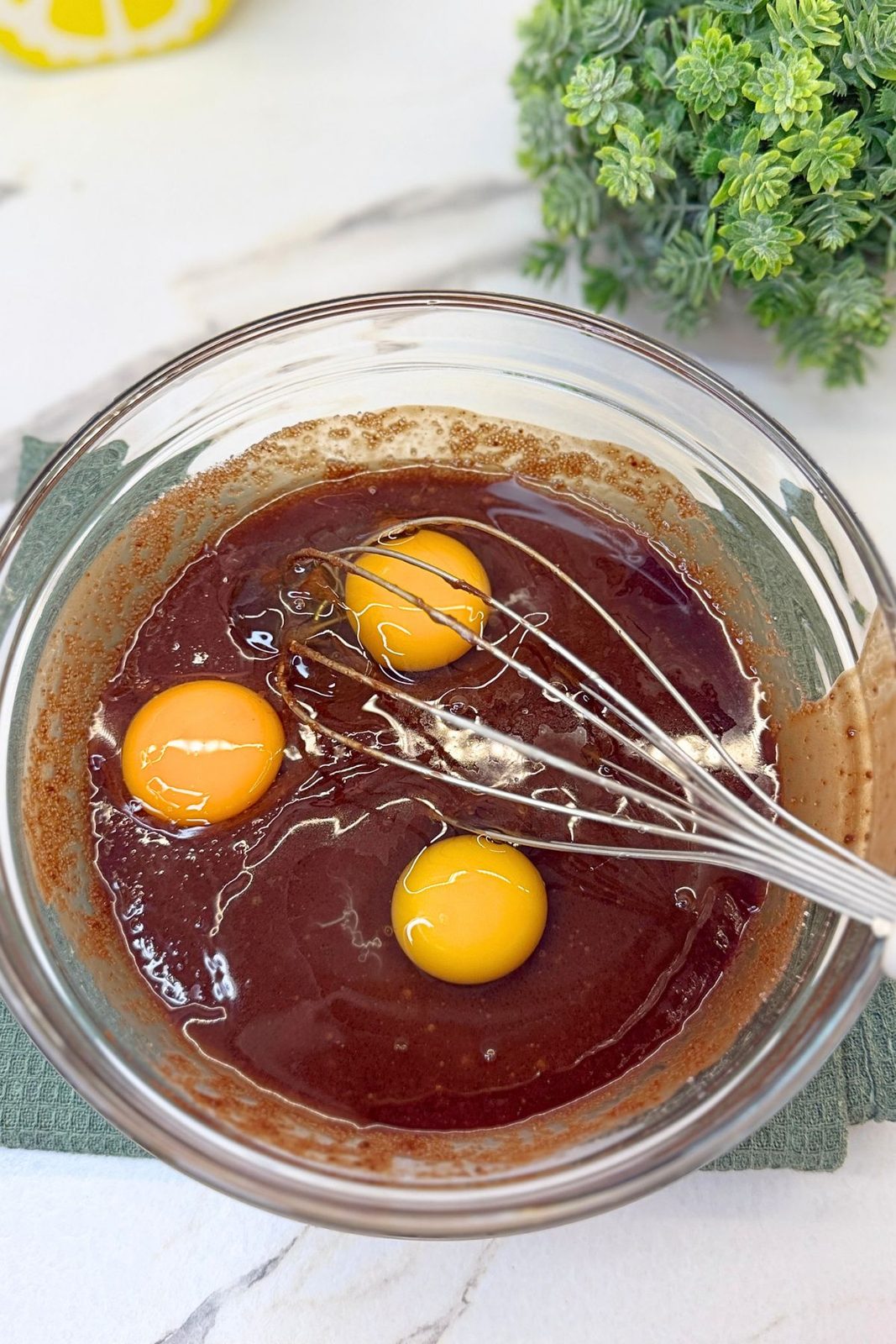 Eggs and an extra egg yolk added to the melted chocolate and butter mixture.