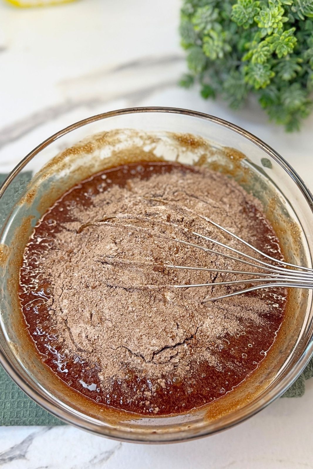 Flour, cocoa powder, and salt added to the wet brownie ingredients.