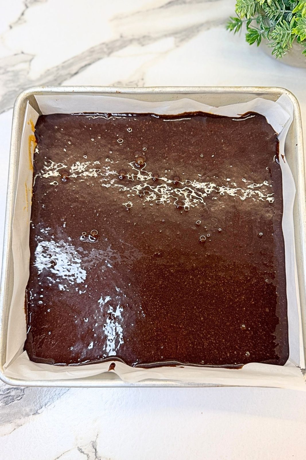 Remaining brownie batter spread evenly over the frozen peanut butter filling.