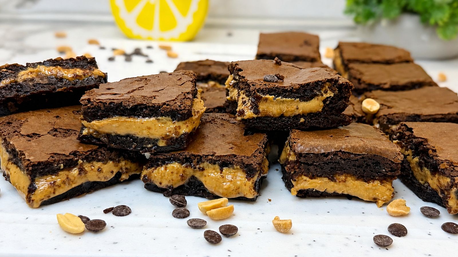 Peanut butter brownies with fudgy chocolate layers and a thick creamy peanut butter center.