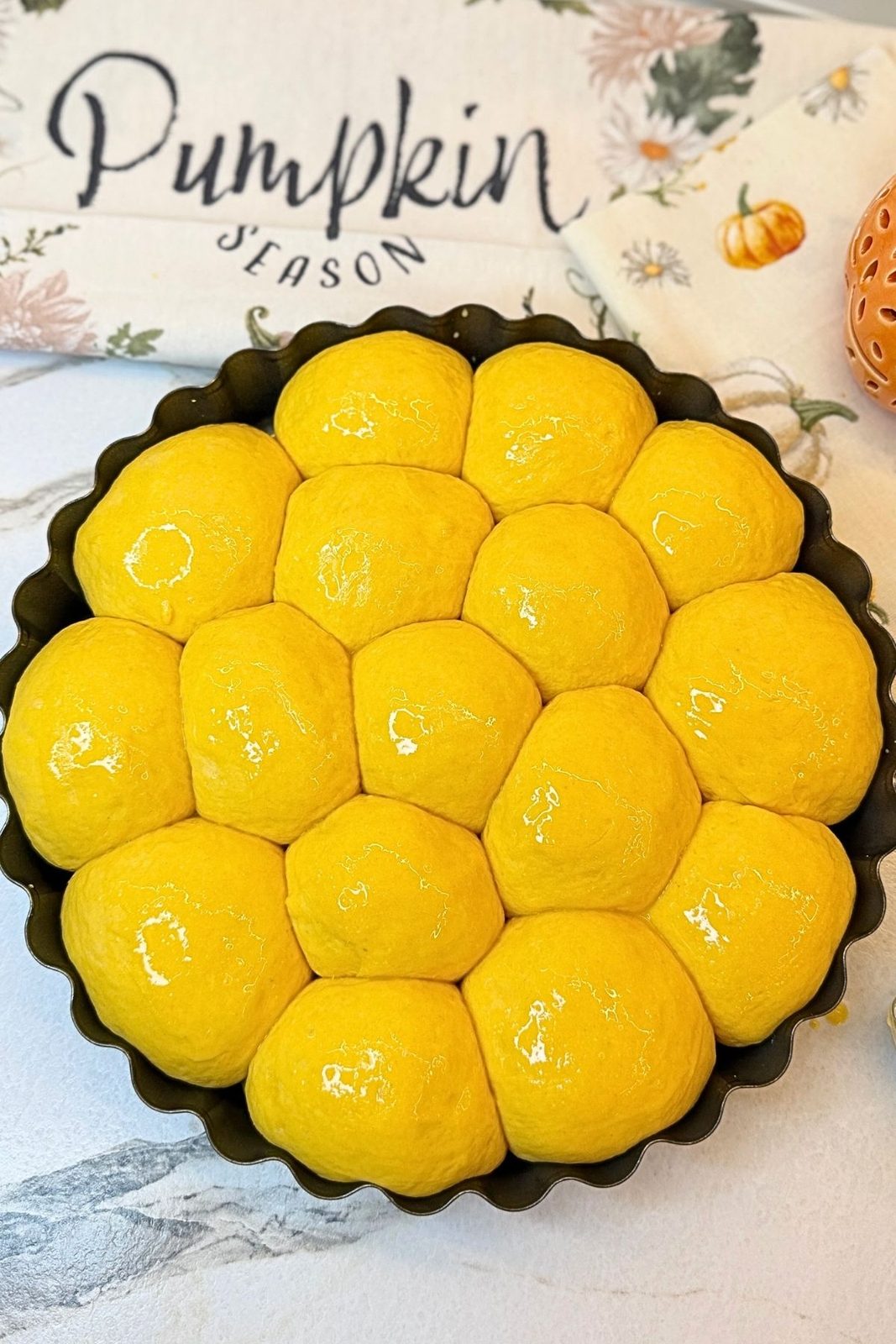 Egg-washed Pumpkin Dinner Rolls ready to bake