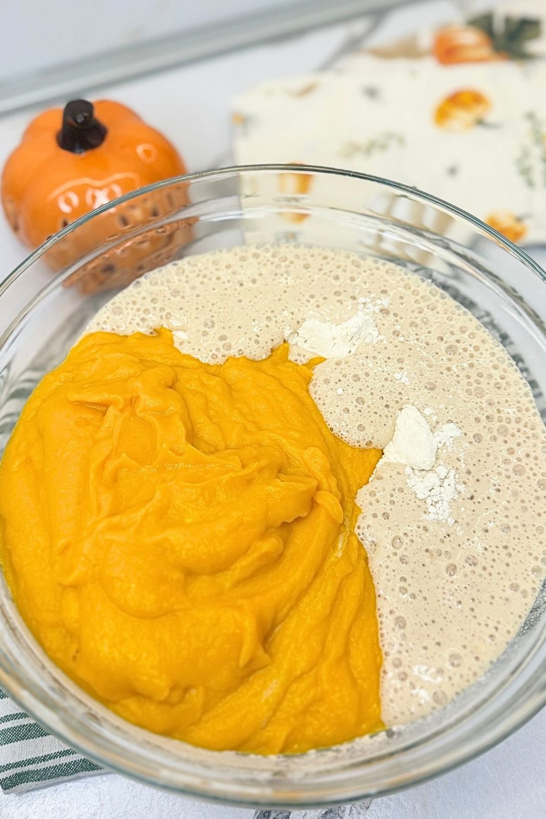 Pumpkin puree and activated yeast added to flour for the dough