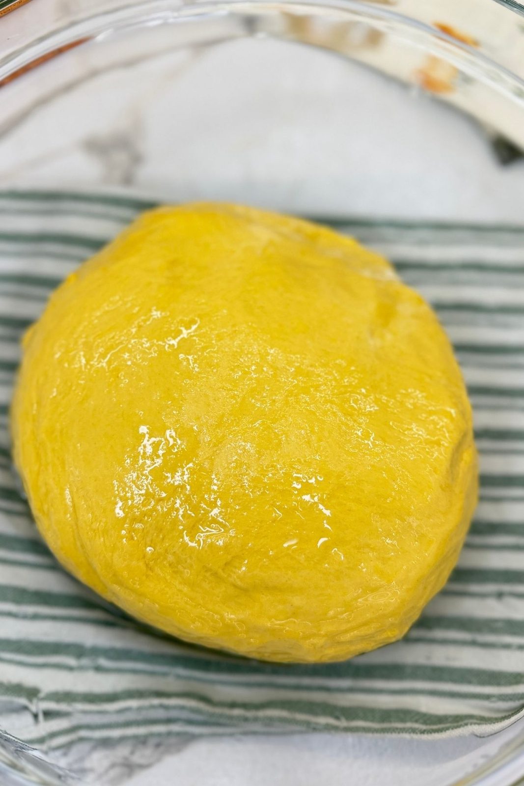 Soft pumpkin dough shaped into a smooth ball after kneading