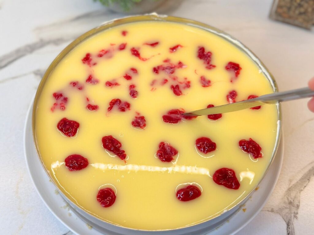 Raspberry filling dotted over the white chocolate ganache for decoration