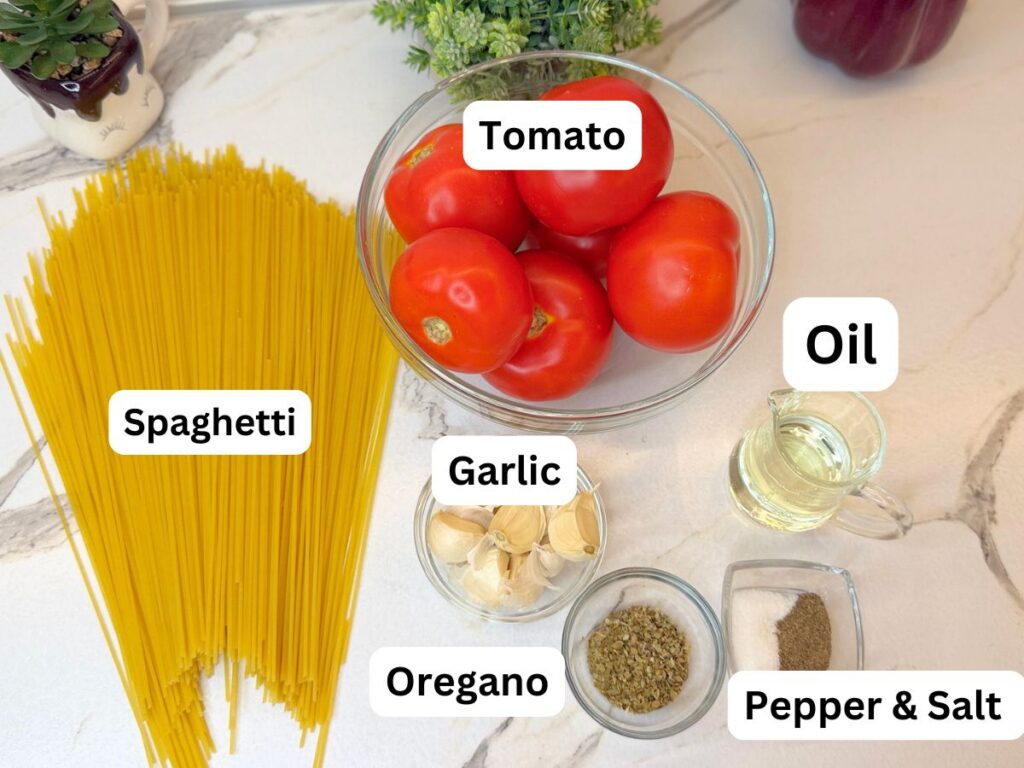 Ingredients for Roasted Tomato Pasta, including fresh tomatoes, garlic, spaghetti, olive oil, oregano, and basil