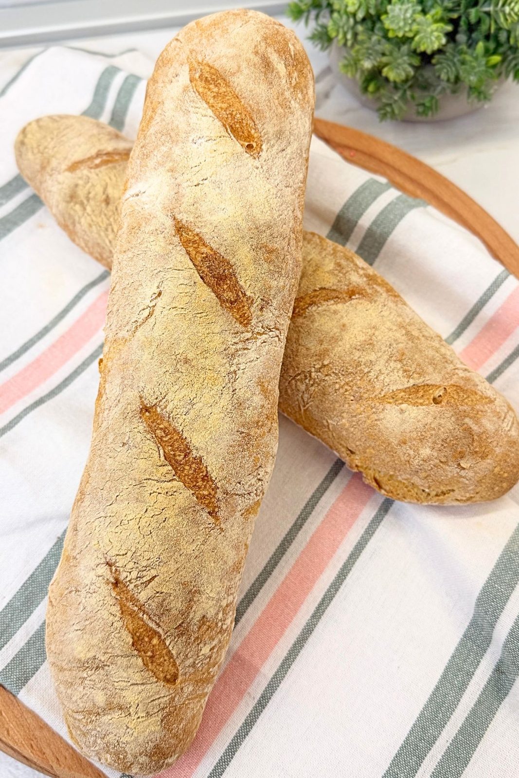 Two freshly baked rustic homemade bread loaves with a golden crispy crust