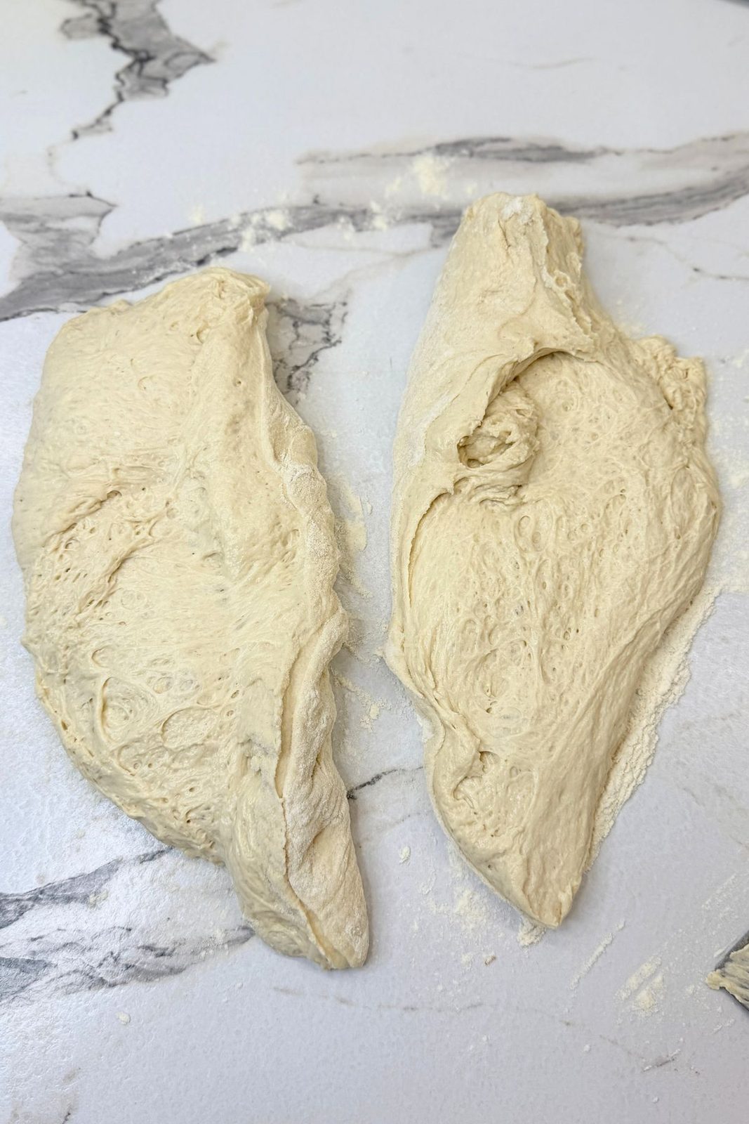 Soft bread dough divided into two equal portions