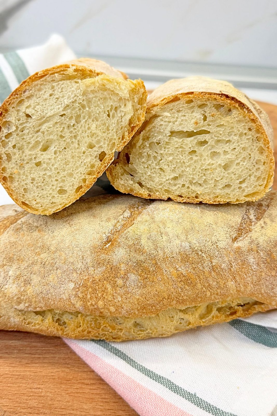 Three freshly baked rustic homemade bread loaves with a golden crispy crust