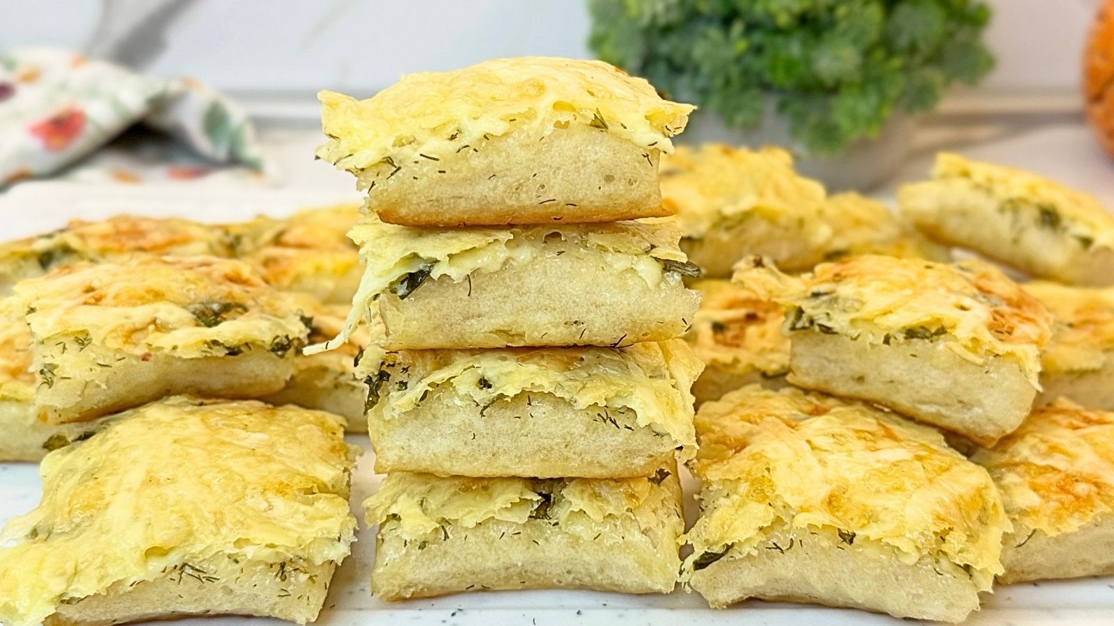 Homemade garlic bread topped with melted cheese and fresh herbs