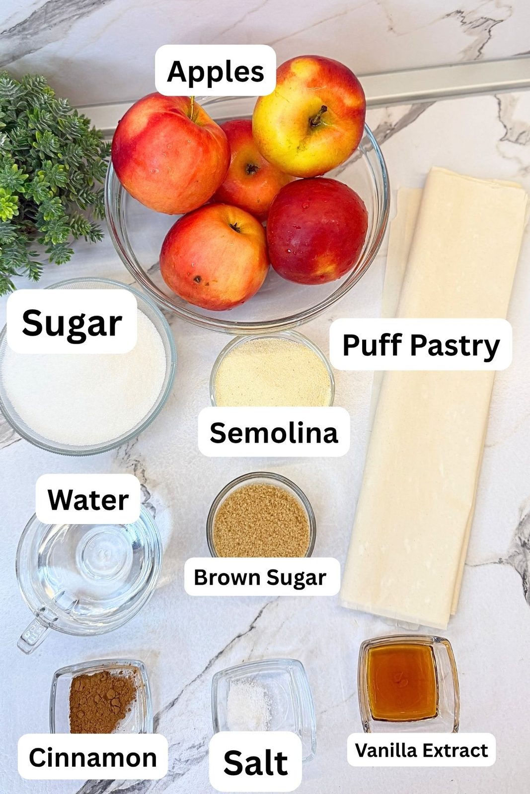 Ingredients for apple phyllo rolls with vanilla syrup, including phyllo dough, apples, semolina, brown sugar, cinnamon, salt, sugar, water, and vanilla extract.