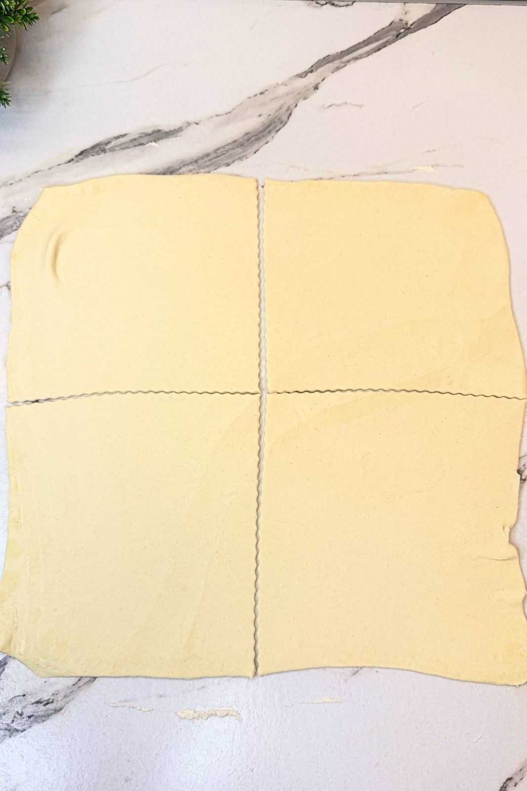 Puff pastry rolled out and cut into four equal squares on a lightly floured surface.