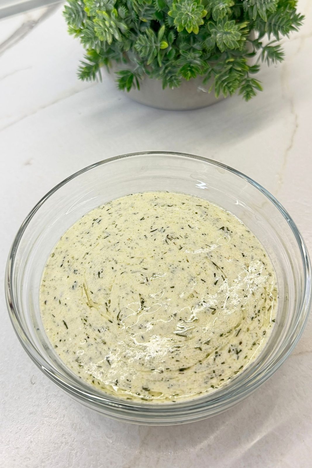 Creamy lemon salad dressing made with sour cream, mayonnaise, olive oil, dill, and seasonings.