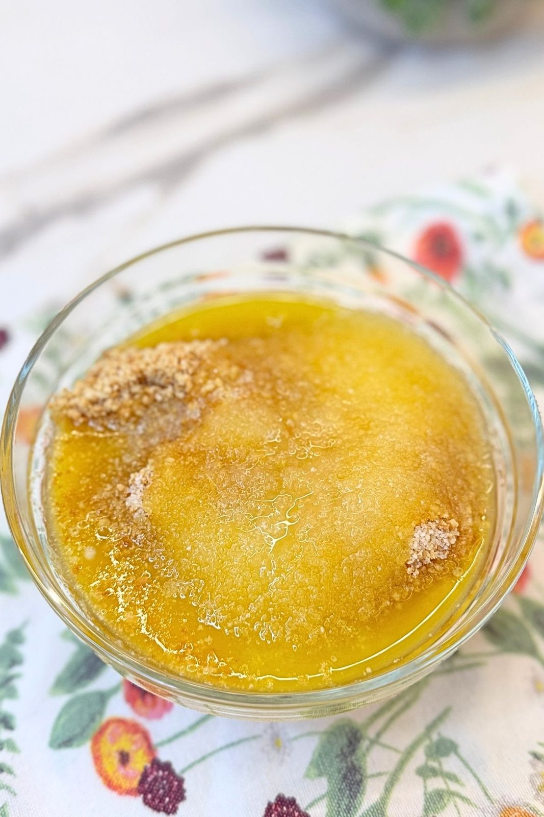 Graham cracker crumbs and melted butter in a bowl for the mini cheesecake crust