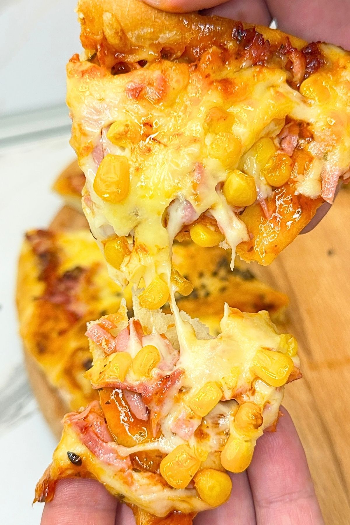 Homemade pizza ring recipe with ham, cheese, corn, and soft pizza dough