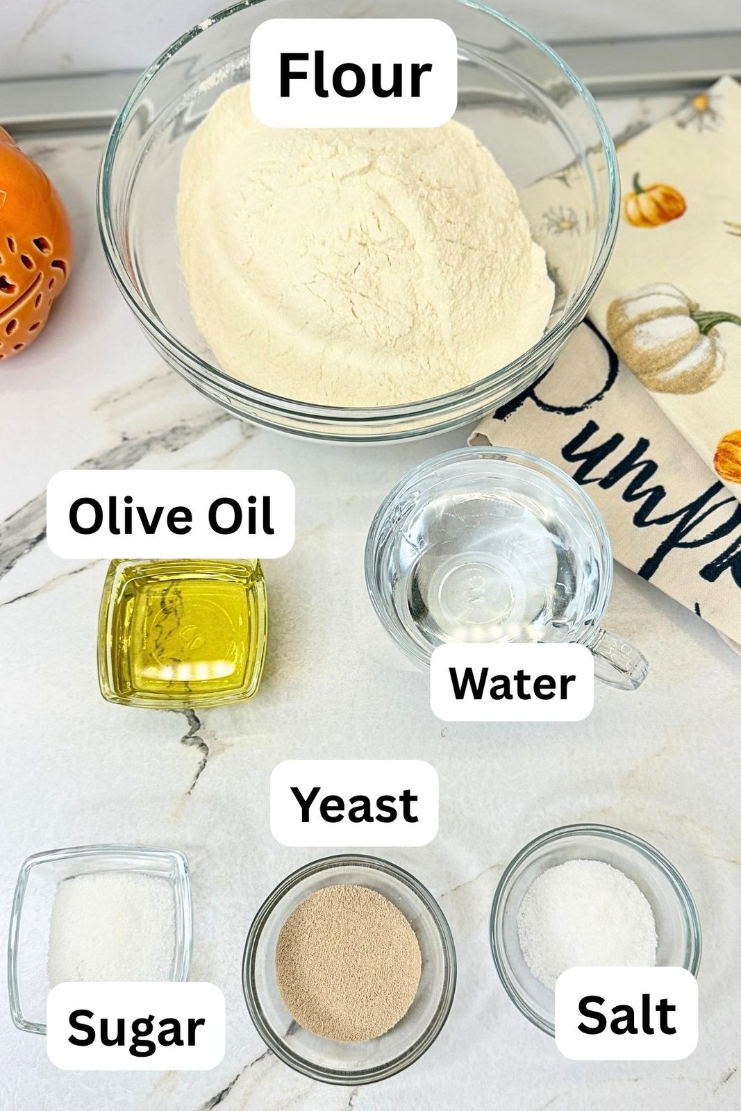 Ingredients for homemade pizza dough including flour, yeast, sugar, salt, olive oil, and warm water