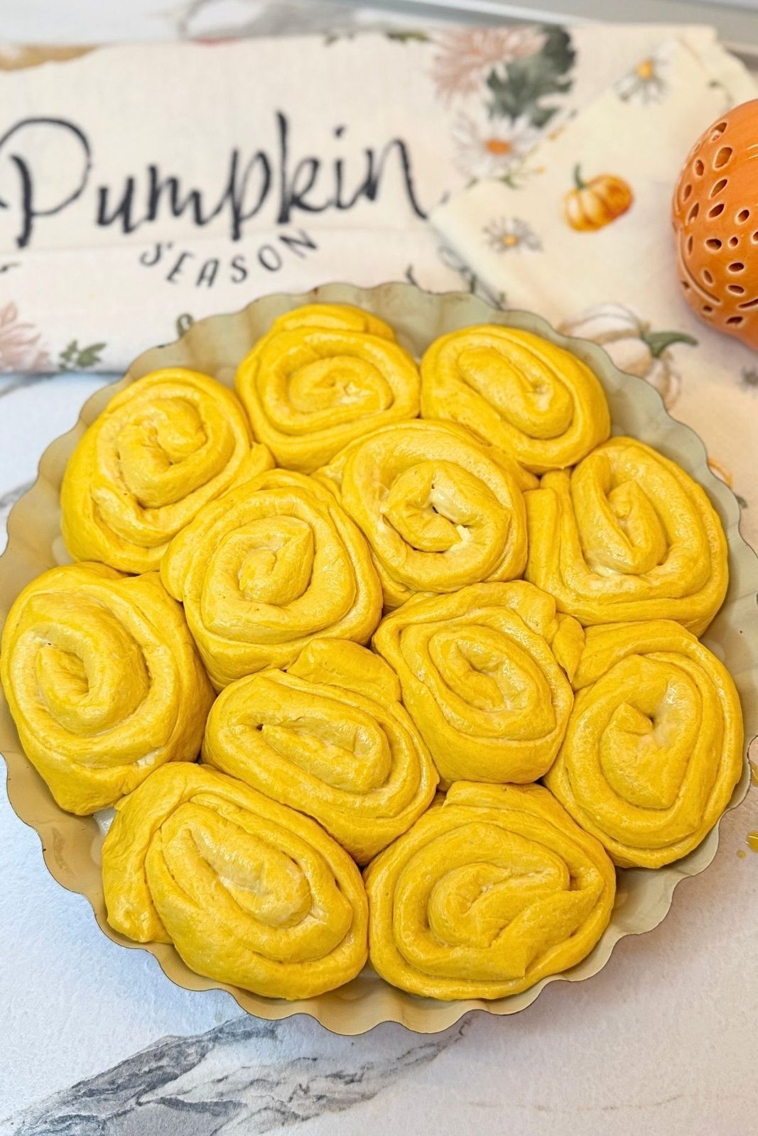 Risen Swirled Pumpkin Dinner Rolls brushed with egg yolk and milk
