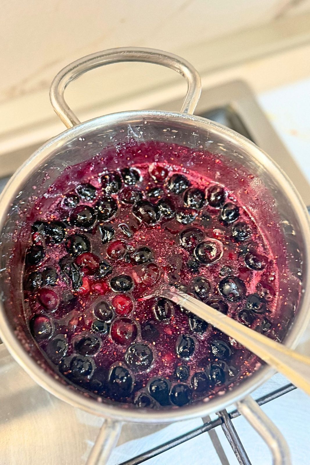 Blueberry turnover filling cooking in a saucepan after stirring in the semolina.