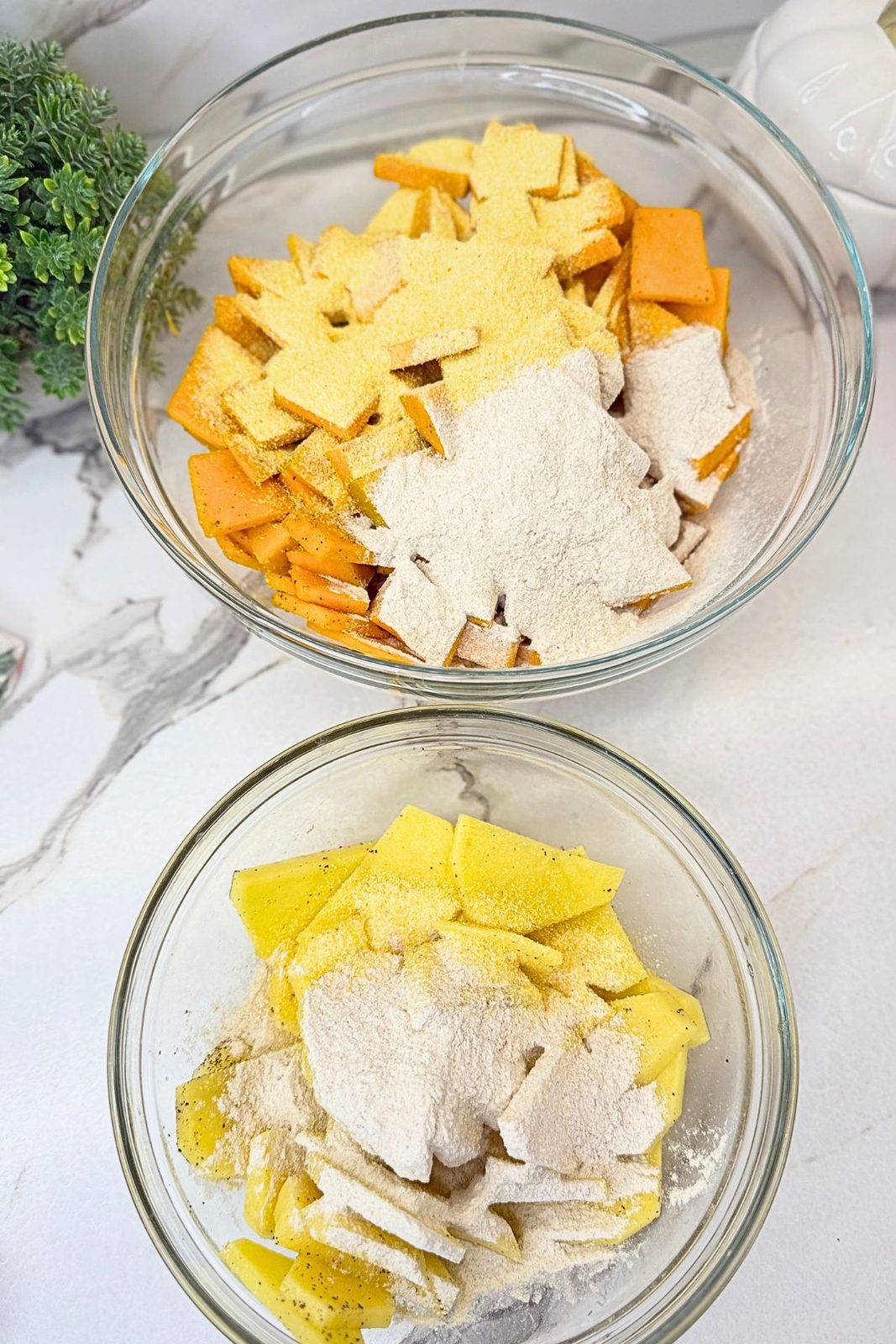 Sliced pumpkin and potatoes topped with cornmeal, buckwheat flour, salt, and black pepper in separate bowls.
