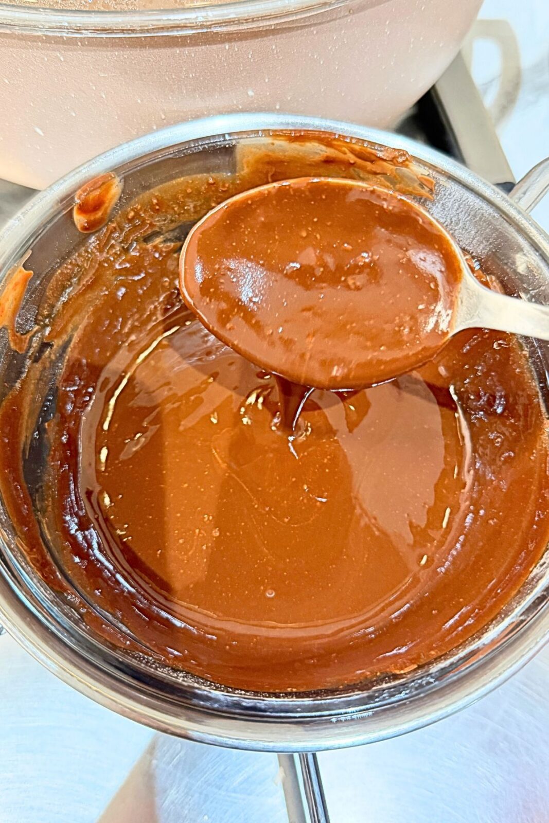 Melted chocolate and butter stirred until smooth in a bowl over simmering water.