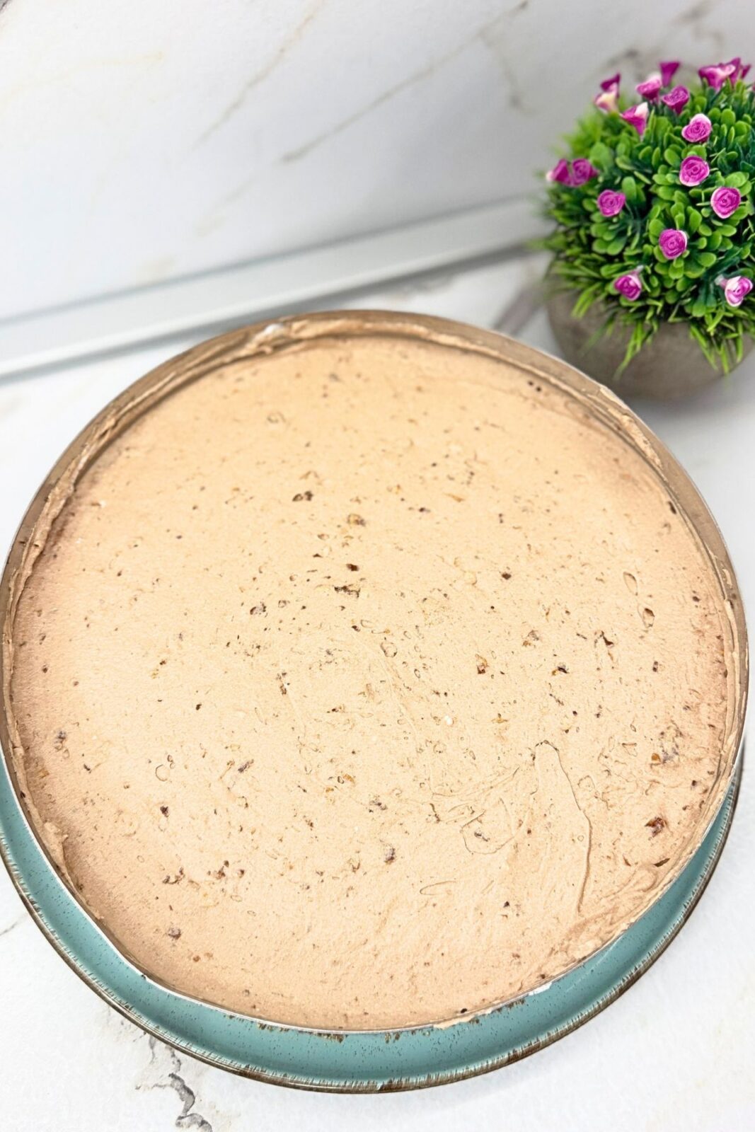 No-bake Ferrero Rocher cake filling smoothed into an even layer before chilling.